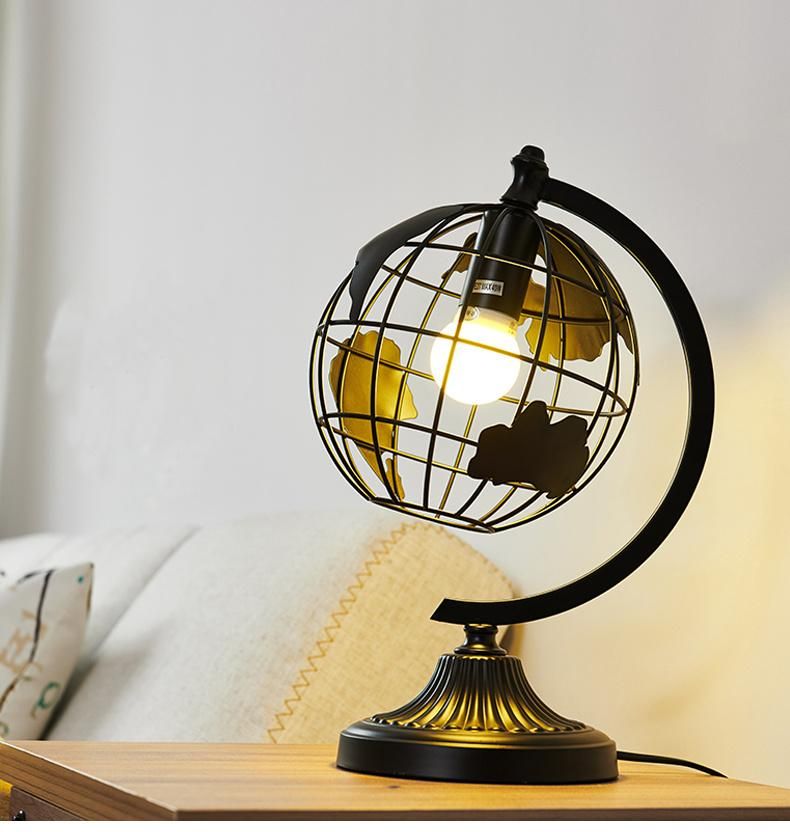 Hot Selling Black Color Iron Metal Sculpture Hollow out Rotation Decorative World Globe LED Table Lamp