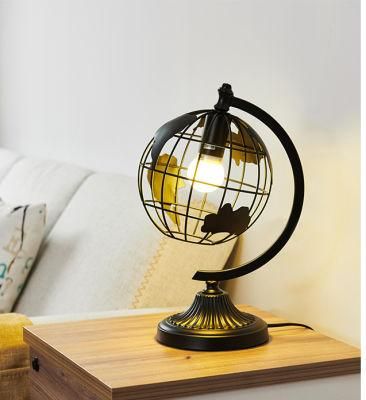 Hot Selling Black Color Iron Metal Sculpture Hollow out Rotation Decorative World Globe LED Table Lamp