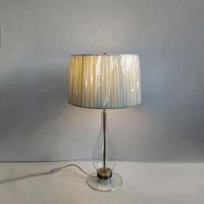 White Pleated Fabric Shade and Clear Glass Body Table Lamp.