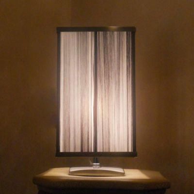 Body in Chrome Finish and Silver String Fabric Shade Table Lamp.