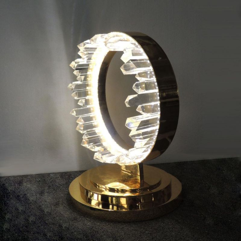 Metal Ring in Gold Plated Finish and Clear Crystal Shade Table Lamp.