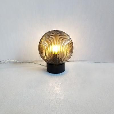 Matte Black Metal Body and Fluted Glass Ball Shade Table Lamp.