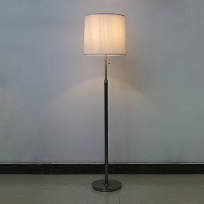 White Fabric Lamp Shade and Satin Nickel Metal Body Floor Lamp.